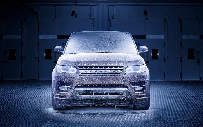 Range Rover covered in ice in a dark room