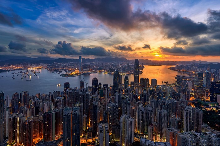 Hong Kong cityscape at sunset with city lights and clouds