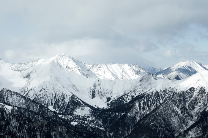 Snow-covered mountains under a cloudy sky