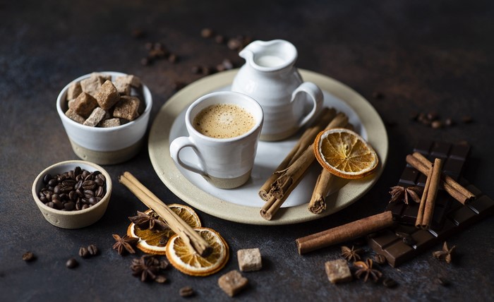 Coffee with chocolate, cinnamon, and sugar cubes