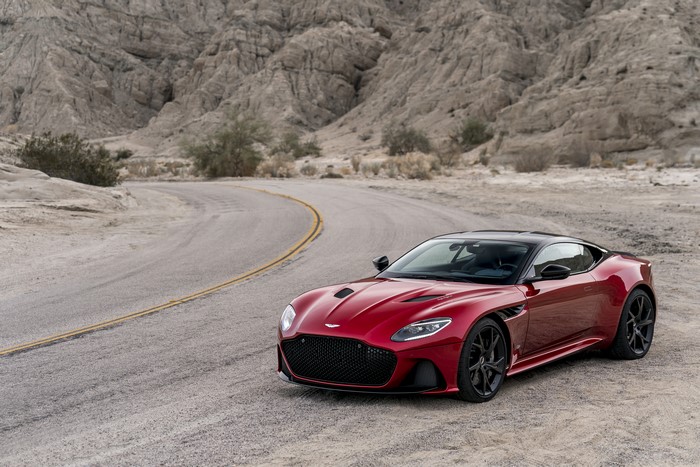 Red Aston Martin DBS Superleggera on a desert road