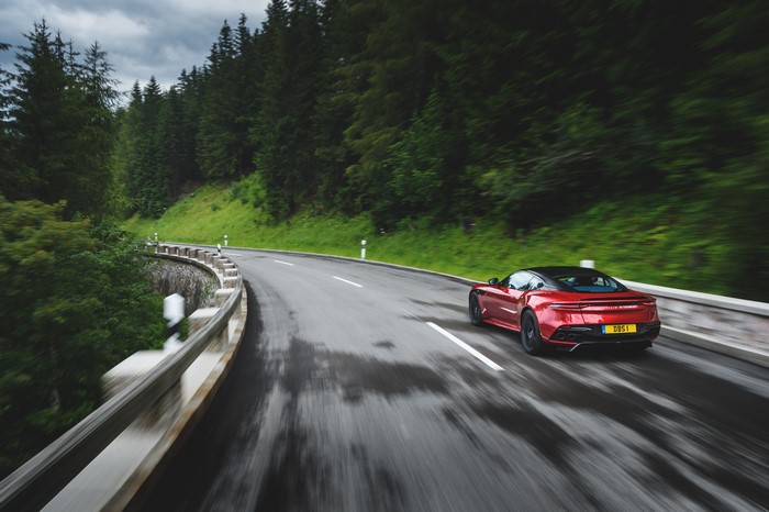 Aston Martin DBS Superleggera driving on a wet mountain road