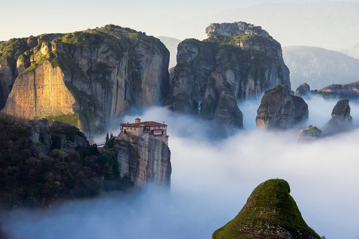 Monastery on a cliff in Meteora, Greece, above the clouds