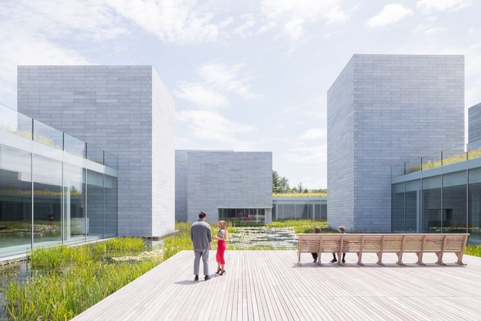 Modern architecture with reflecting pool and people