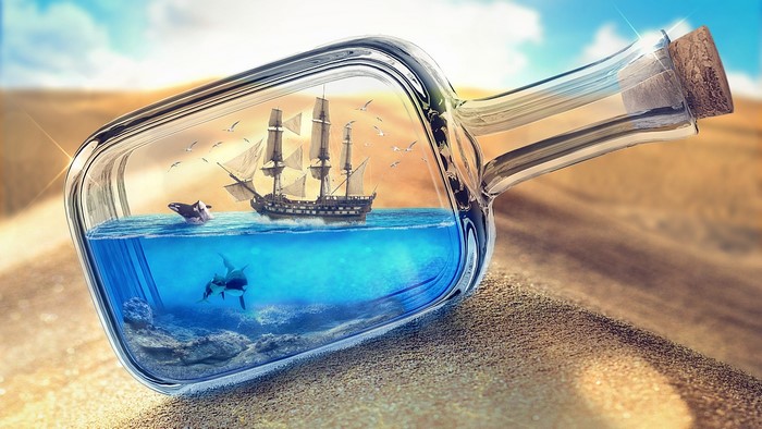 Ship in a bottle with sharks and orcas in desert