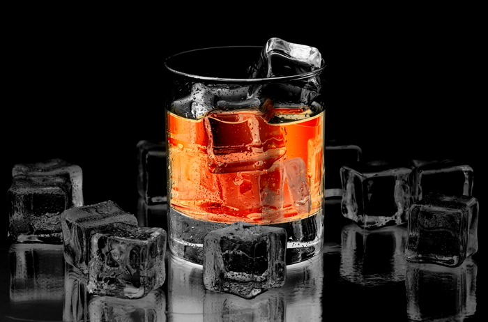 Whiskey in a glass with ice cubes