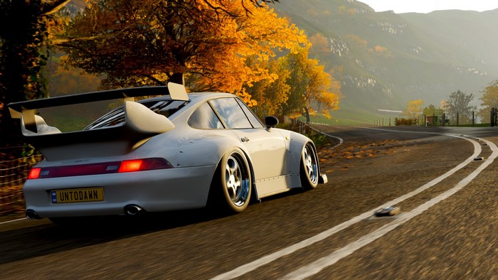 White Porsche 911 GT2 on a road in Forza Horizon 4