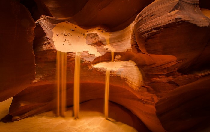 Sand falling in a sandstone canyon