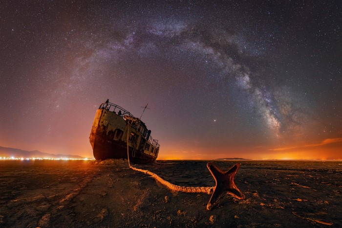 Shipwreck under the Milky Way with anchor