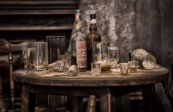 Whiskey bottles and glasses on a wooden table