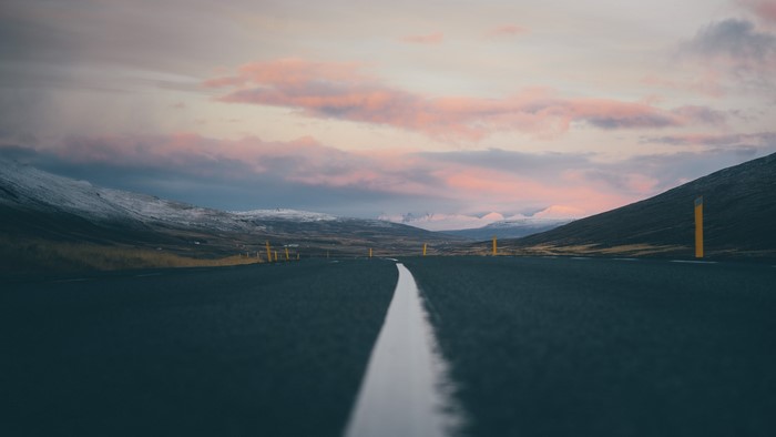 Road through mountains at sunset