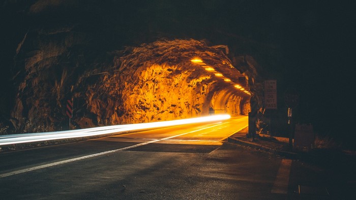 Long exposure of light trails in a tunnel at night