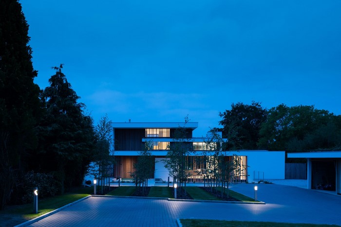 Modern luxury house at dusk with exterior lighting