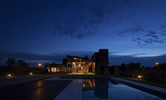 Modern house with swimming pool at night
