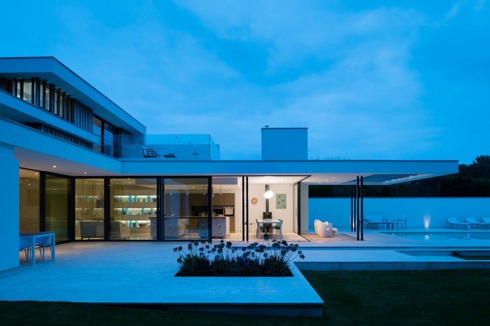 Modern luxury house with swimming pool at dusk