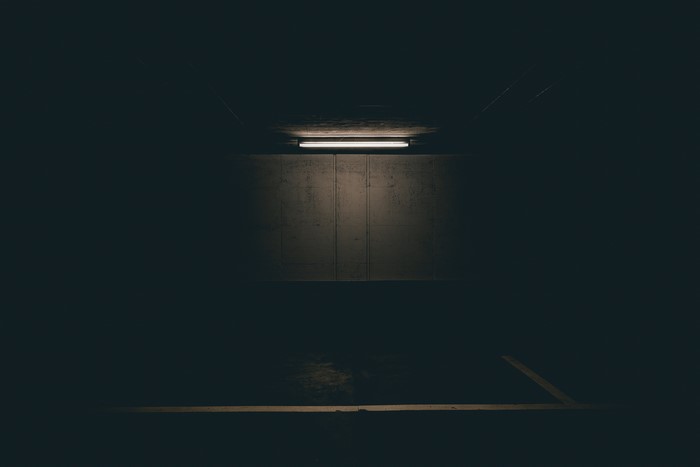 Dark parking garage with fluorescent light