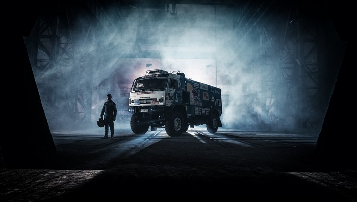 Kamaz truck with driver in smoky hangar