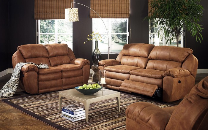 Brown leather reclining sofas in a living room