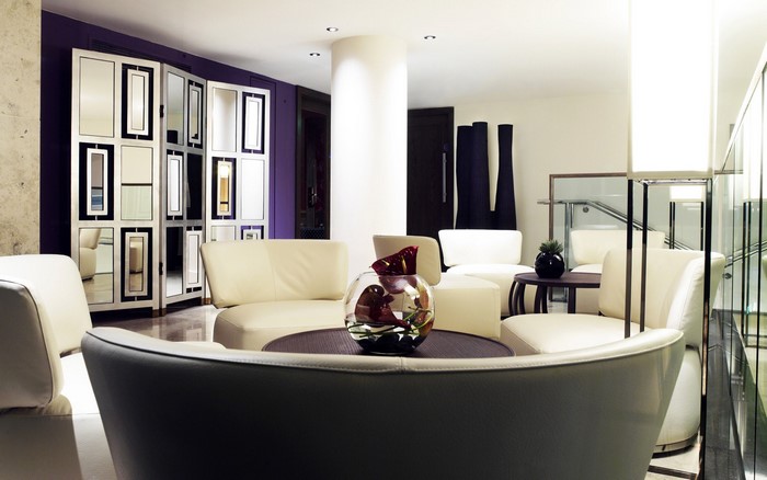 Modern living room with white sofas and decorative screen
