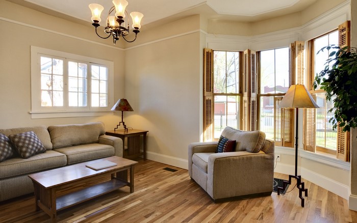 Living room with couch, armchair, and bay windows