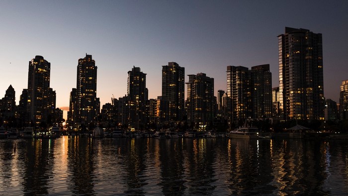Vancouver cityscape at dusk with water reflection