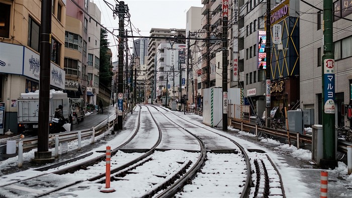 Snowy Tokyo street with tram tracks