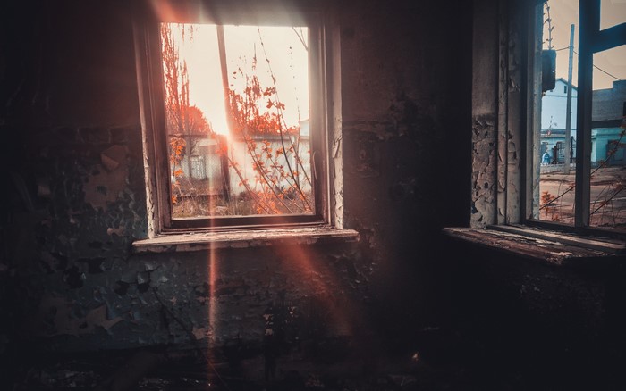 Sun rays through a window in a ruined house