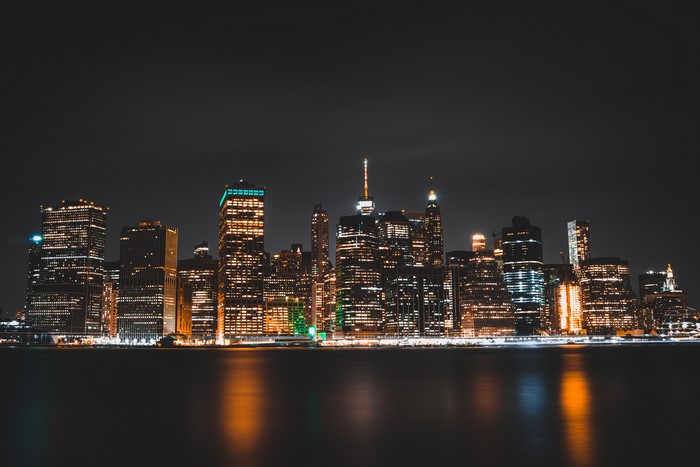 New York City skyline at night with reflections
