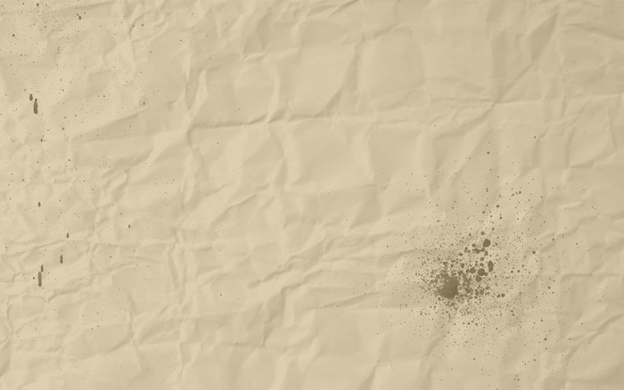 Crumpled paper texture with ink splatters