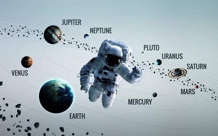 Astronaut floating in space with planets of the Solar System