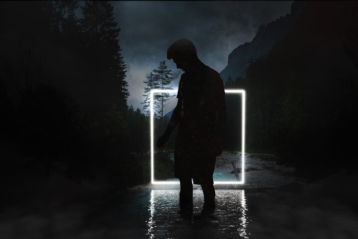 Silhouette in a neon square in a dark forest