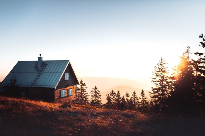 Cabin in the mountains at sunset
