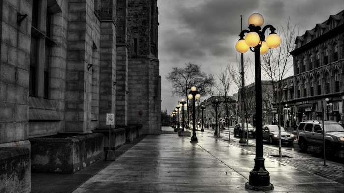 Street lights and cars on a rainy city street