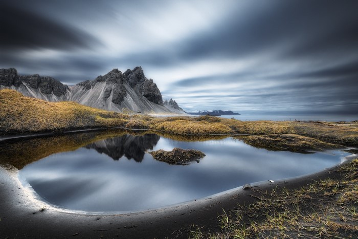 Jagged mountains reflected in a tidal pool in Iceland