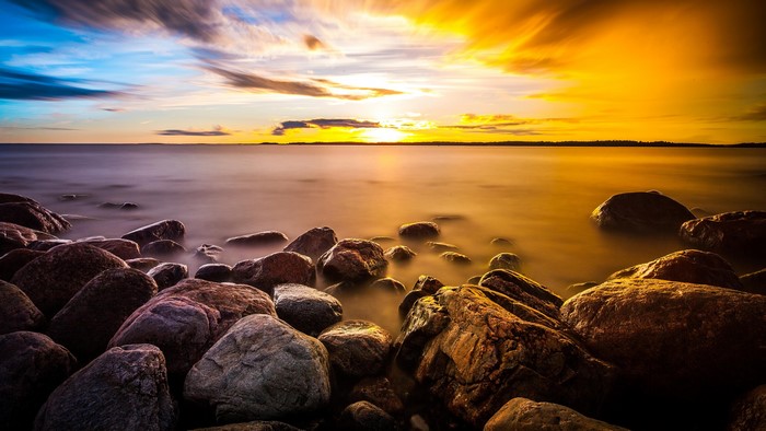 4K stones on a rocky shore at sunset