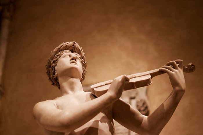 Marble sculpture of Apollo playing a violin