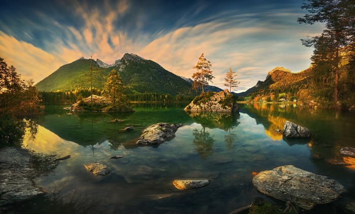 Lake landscape with mountains, trees, and rocks