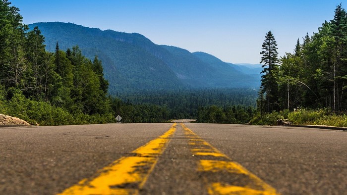 Road through mountains and forest