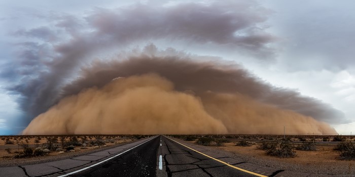 Dust storm approaching on a desert highway