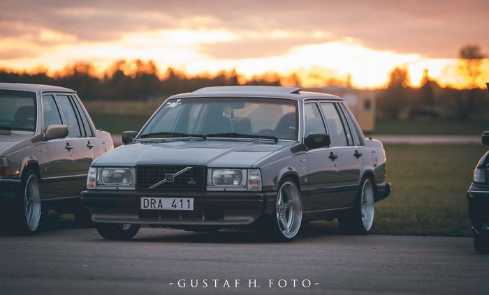 Volvo 740 Sedan with custom wheels at sunset