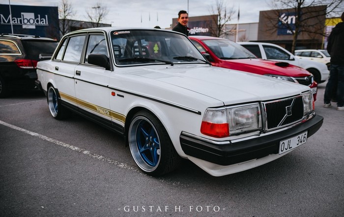 White Volvo 240 Sedan with Gold Stripe