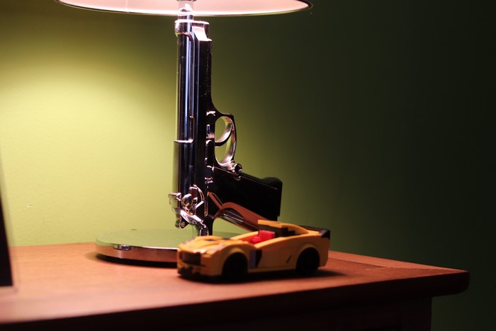 Pistol lamp and toy car on a table
