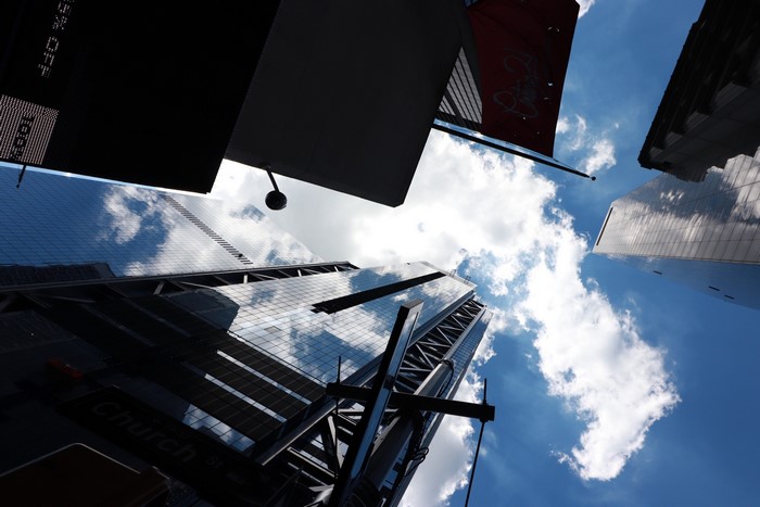 Looking up at skyscrapers and clouds in New York City