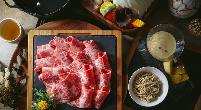 Thinly sliced raw beef and hot pot ingredients