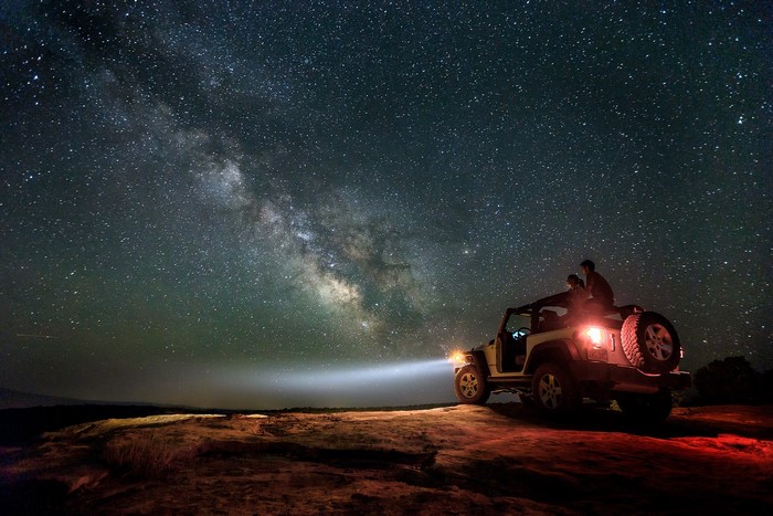 Couple in Jeep under Milky Way in Utah