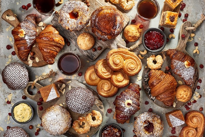 Assortment of pastries, croissants, and coffee