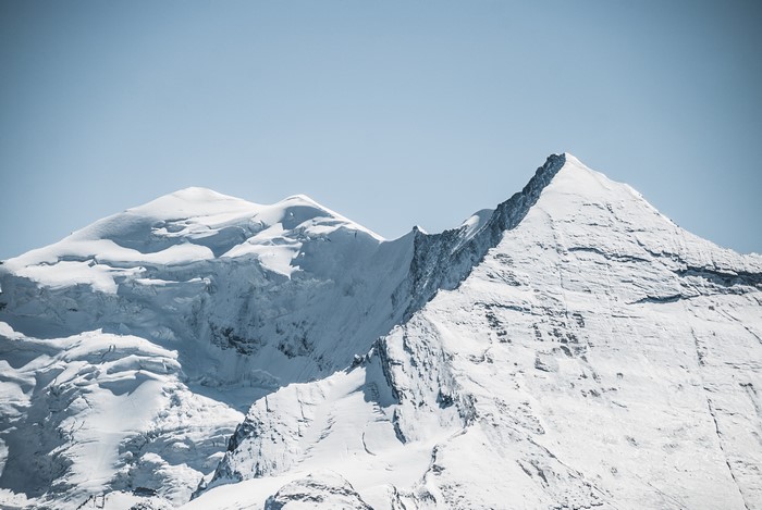 Snow-covered mountains under a clear blue sky