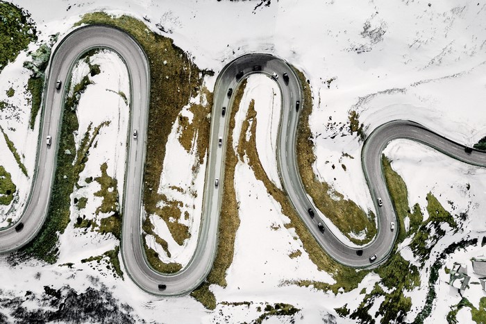 Aerial view of a winding mountain road in winter