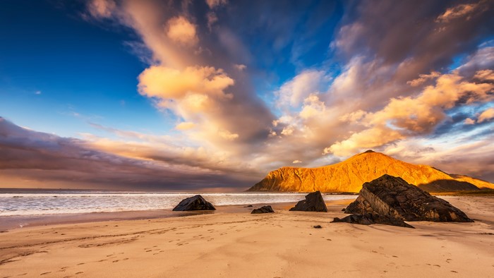 Beach with mountain and dramatic clouds