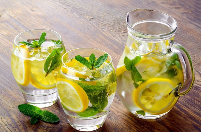 Pitcher and glasses of lemonade with lemon and mint